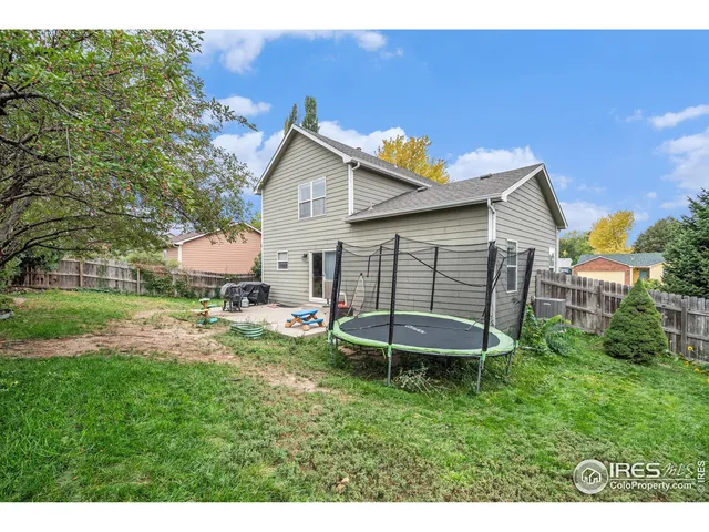 a view of a backyard with table and chairs and potted plants