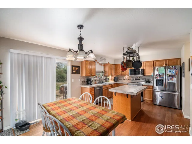 a kitchen with stainless steel appliances granite countertop a stove a sink dishwasher and cabinets with wooden floor