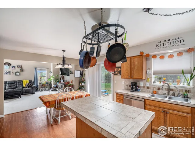 a kitchen with a stove a clock and cabinets
