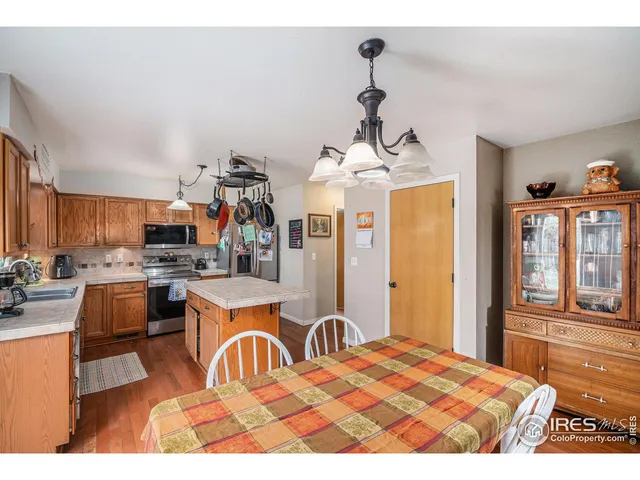 a open kitchen with stainless steel appliances kitchen island granite countertop a sink cabinets and window
