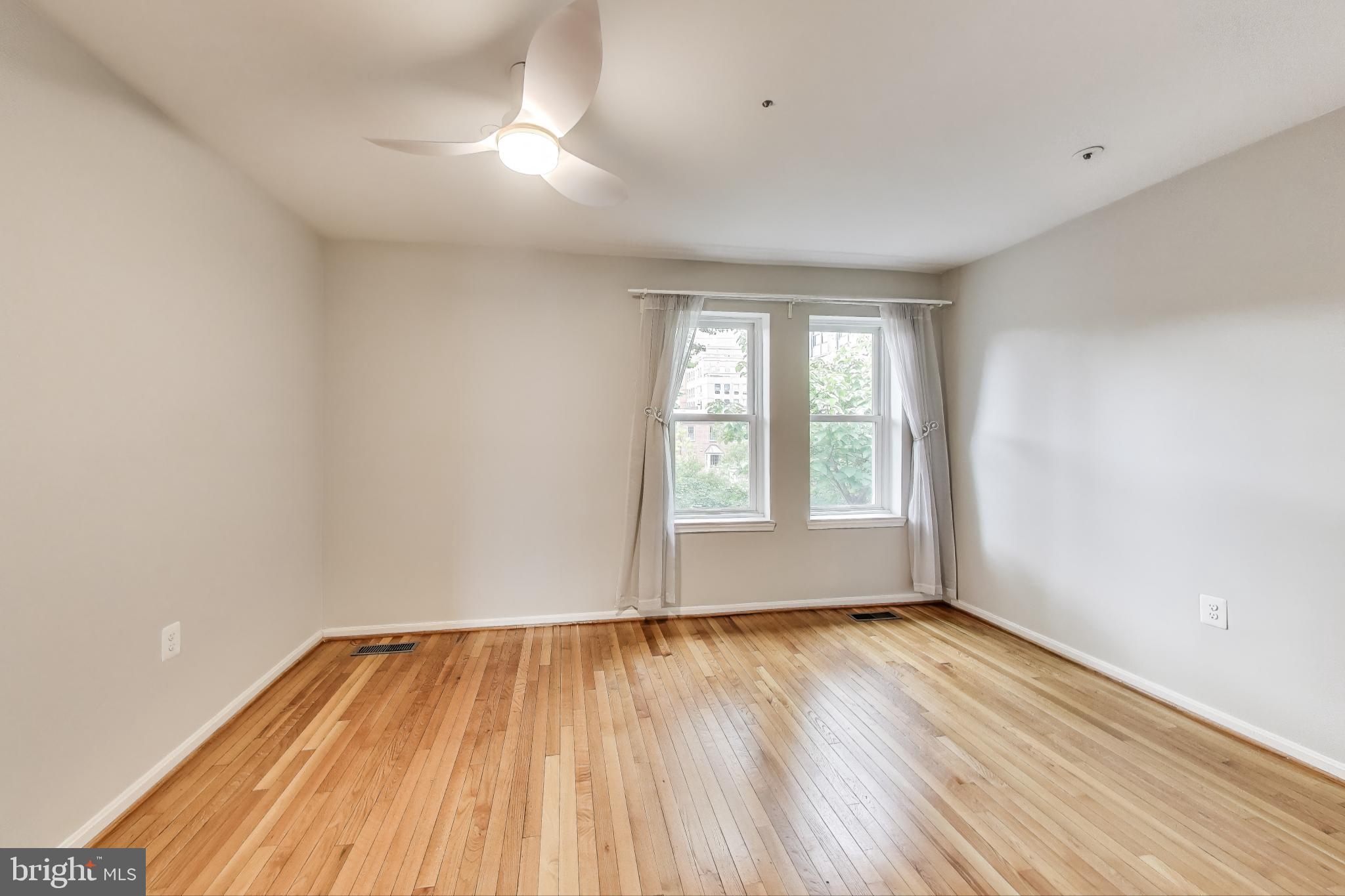 763 3rd Street Northeast Washington, DC 20002 - Photo 14 of 32 wooden floor in an empty room with a window