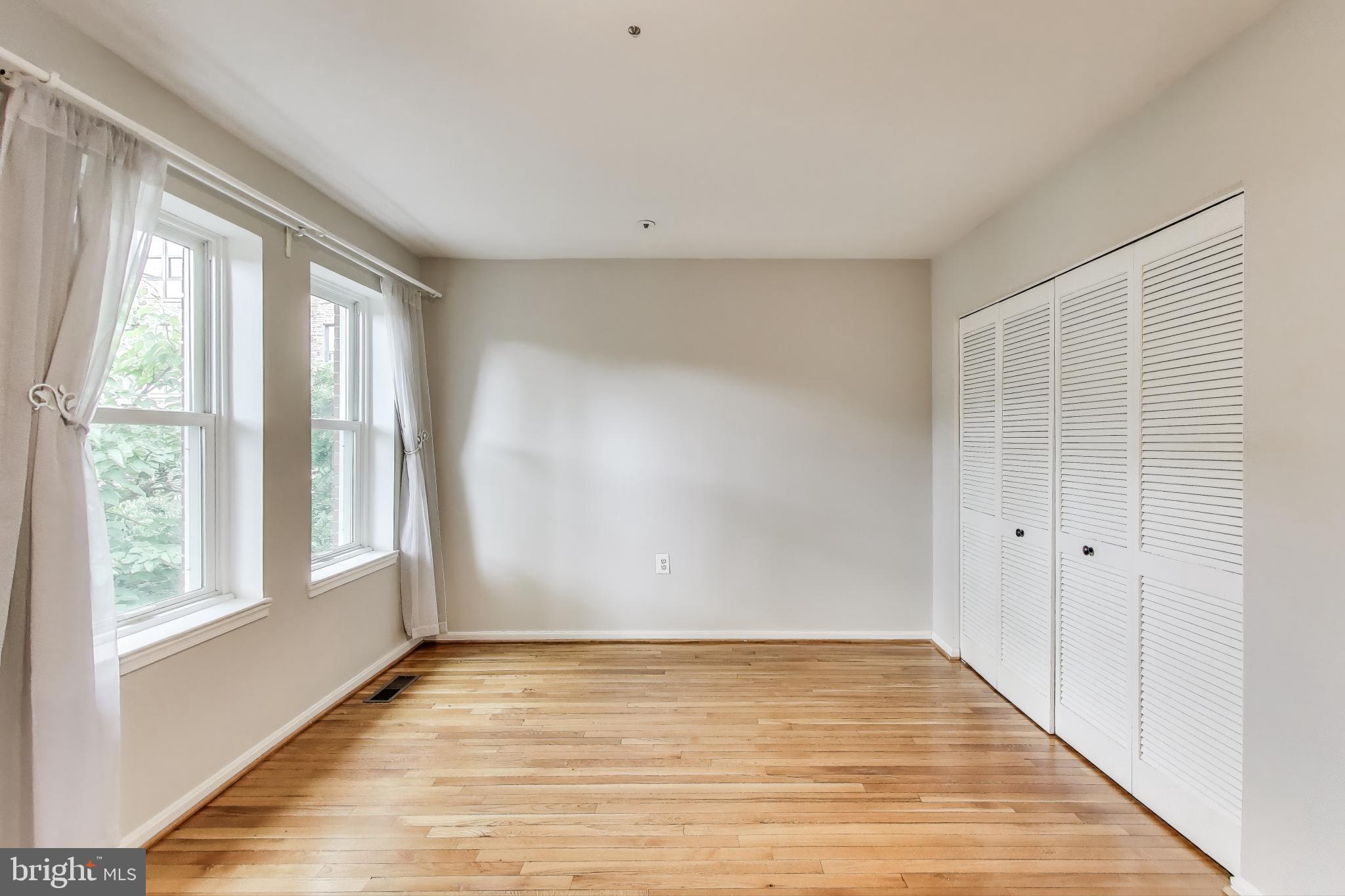763 3rd Street Northeast Washington, DC 20002 - Photo 15 of 32 a view of an empty room with wooden floor and a window