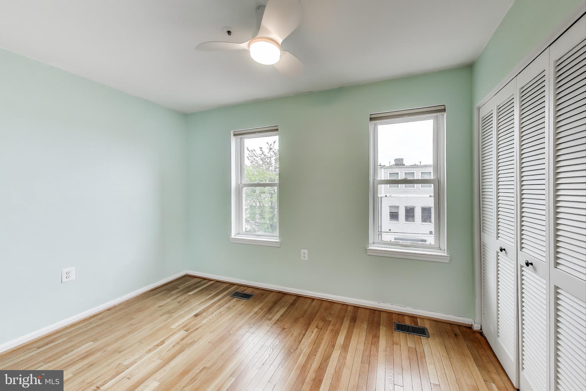 763 3rd Street Northeast Washington, DC 20002 - Photo 18 of 32 an empty room with wooden floor and windows