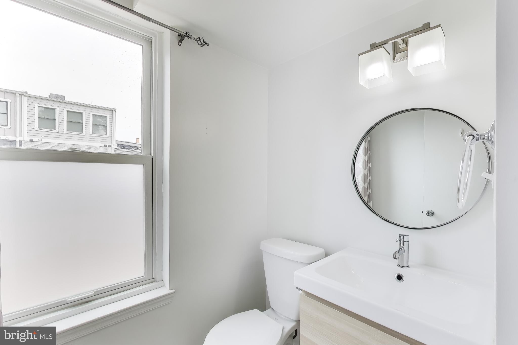 763 3rd Street Northeast Washington, DC 20002 - Photo 8 of 32 a bathroom with a sink mirror and toilet