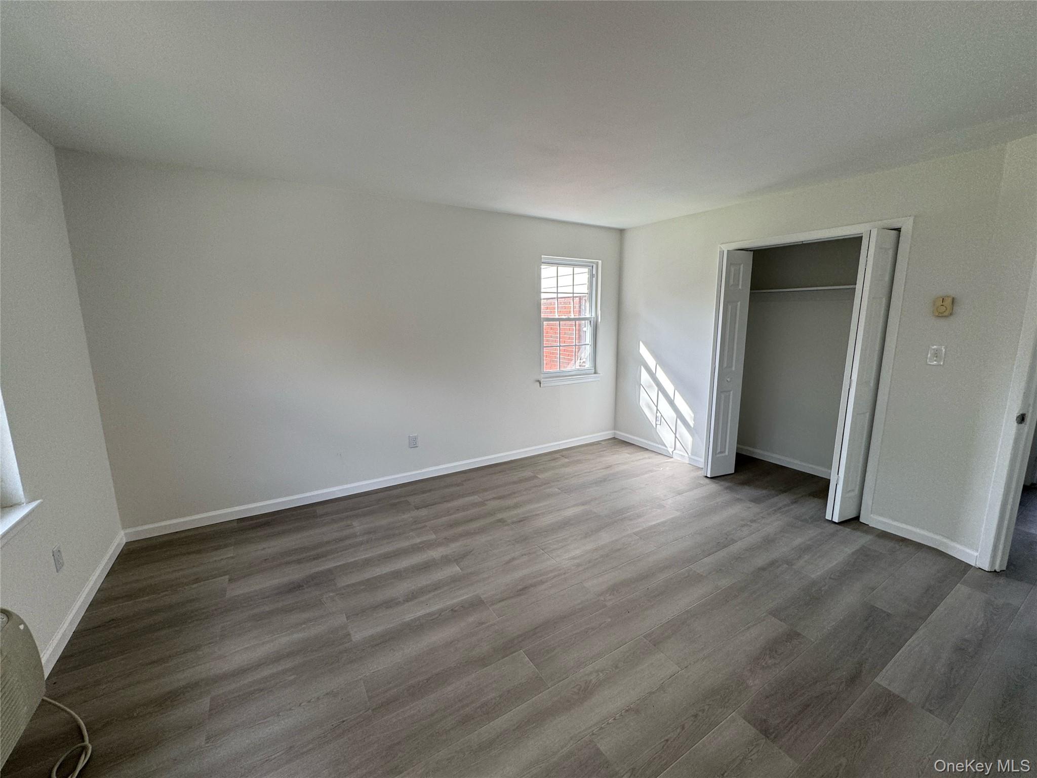 5 Wildwood Drive, Unit 5C Wappingers Falls, NY 12590 - Photo 11 of 11 an empty room with wooden floor and window