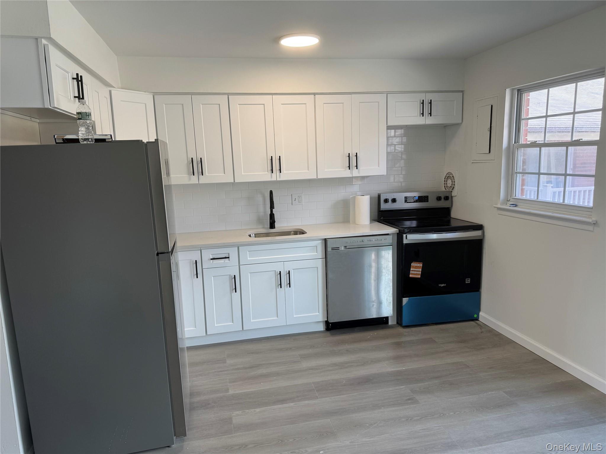 5 Wildwood Drive, Unit 5C Wappingers Falls, NY 12590 - Photo 4 of 11 a kitchen with a white cabinets and white appliances