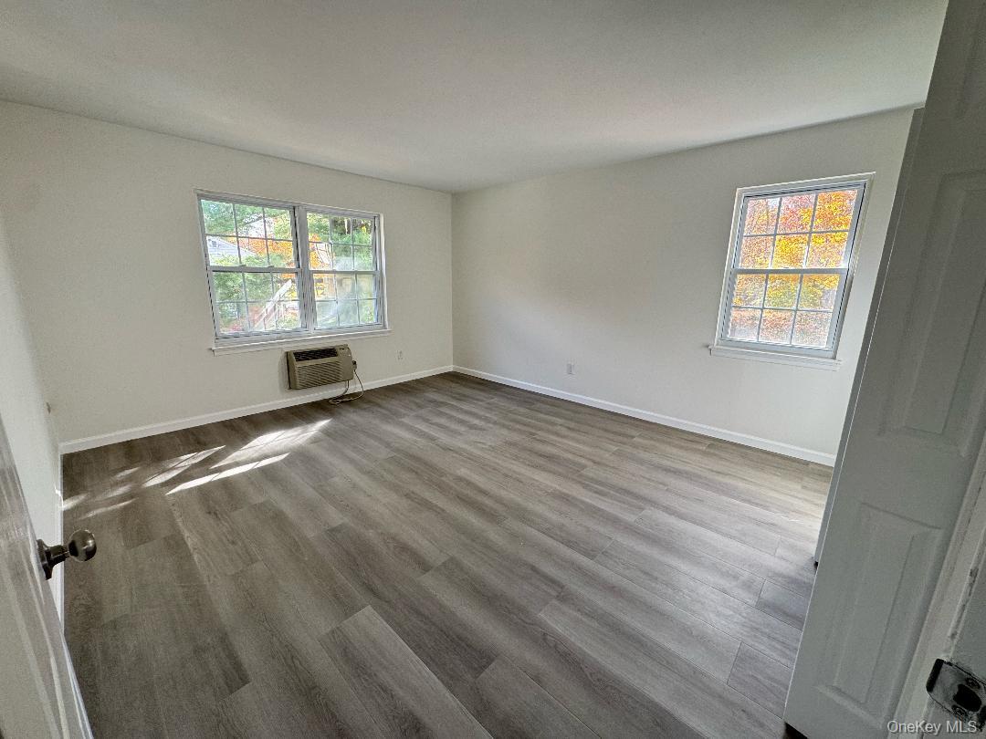 5 Wildwood Drive, Unit 5C Wappingers Falls, NY 12590 - Photo 6 of 11 wooden floor in an empty room with a window