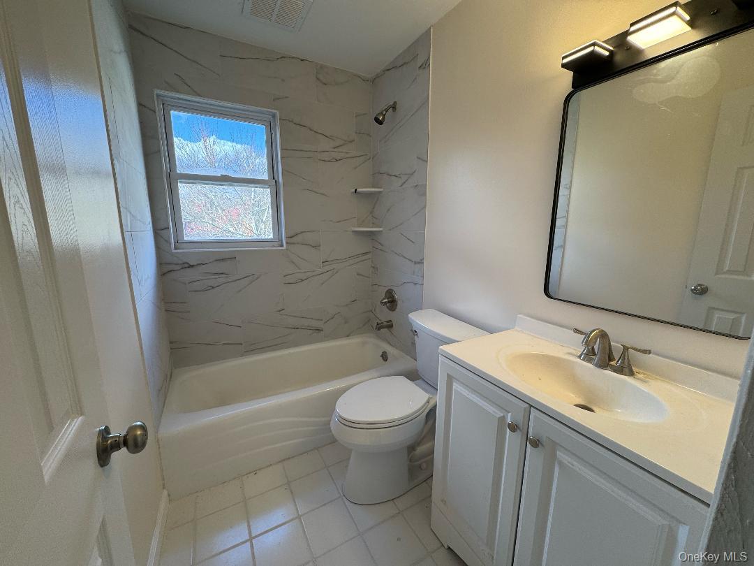 5 Wildwood Drive, Unit 5C Wappingers Falls, NY 12590 - Photo 7 of 11 a bathroom with a granite countertop sink toilet and shower