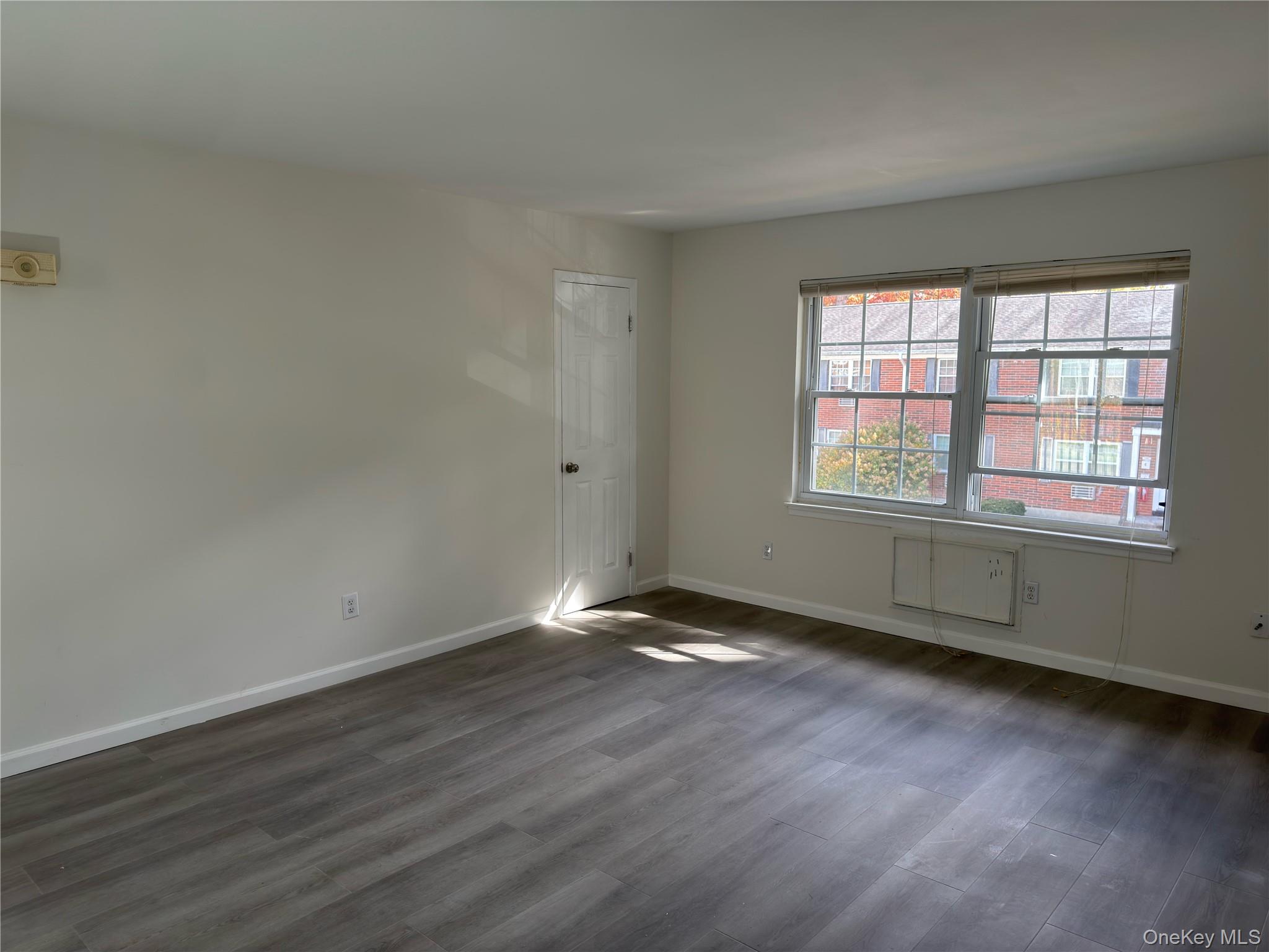 5 Wildwood Drive, Unit 5C Wappingers Falls, NY 12590 - Photo 8 of 11 an empty room with wooden floor and windows