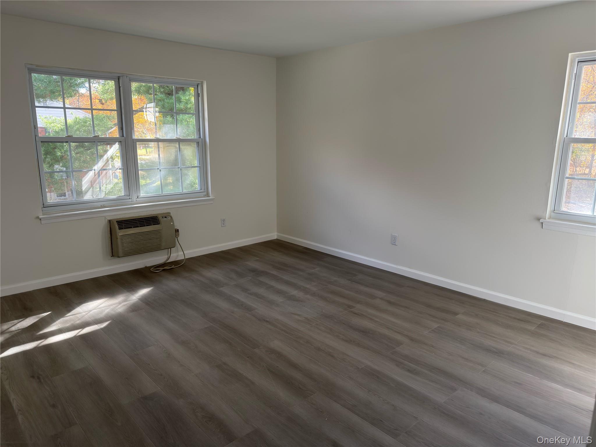 5 Wildwood Drive, Unit 5C Wappingers Falls, NY 12590 - Photo 9 of 11 an empty room with wooden floor and windows