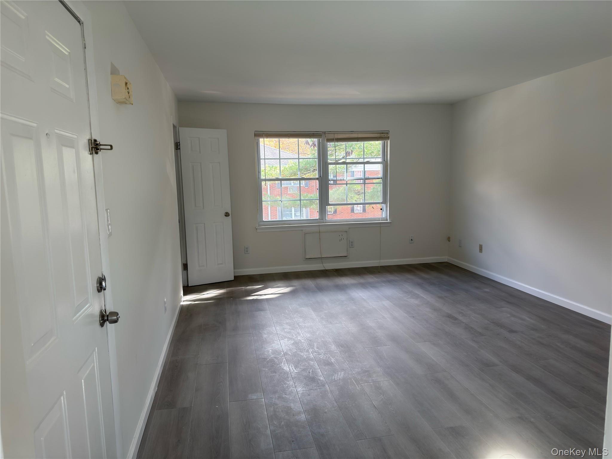 5 Wildwood Drive, Unit 5C Wappingers Falls, NY 12590 - Photo 10 of 11 an empty room with wooden floor and windows