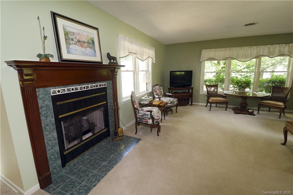 44 Jervey Road, Unit 2B Tryon, NC 28782 - Photo 12 of 24 a living room with furniture a flat screen tv and a fireplace