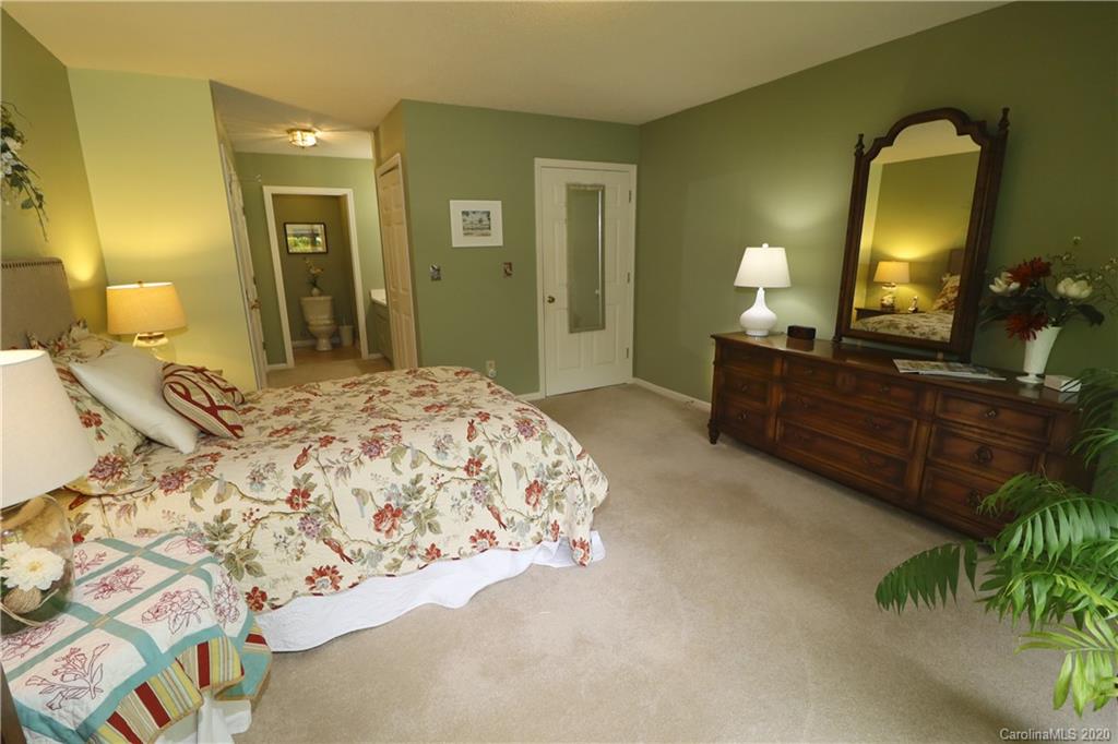 44 Jervey Road, Unit 2B Tryon, NC 28782 - Photo 18 of 24 a bedroom with a bed and a mirror on dresser