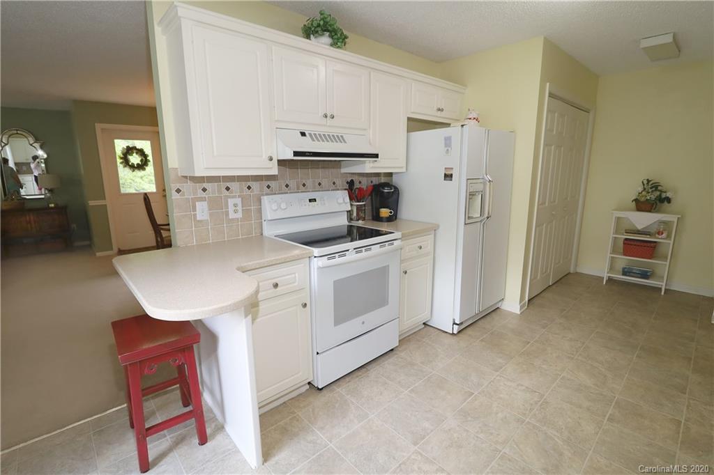 44 Jervey Road, Unit 2B Tryon, NC 28782 - Photo 5 of 24 a kitchen with stainless steel appliances a white stove top oven and a refrigerator