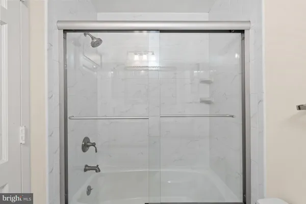 a bathroom with a glass shower door