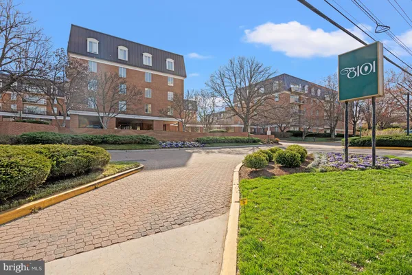 a view of a street with a building and a street sign