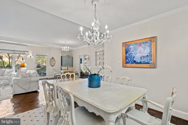 a view of a dining room with furniture wooden floor and chandelier