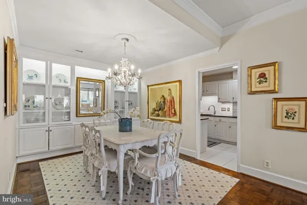 a view of a dining room with furniture and a chandelier
