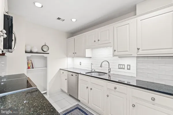 a kitchen with sink and cabinets
