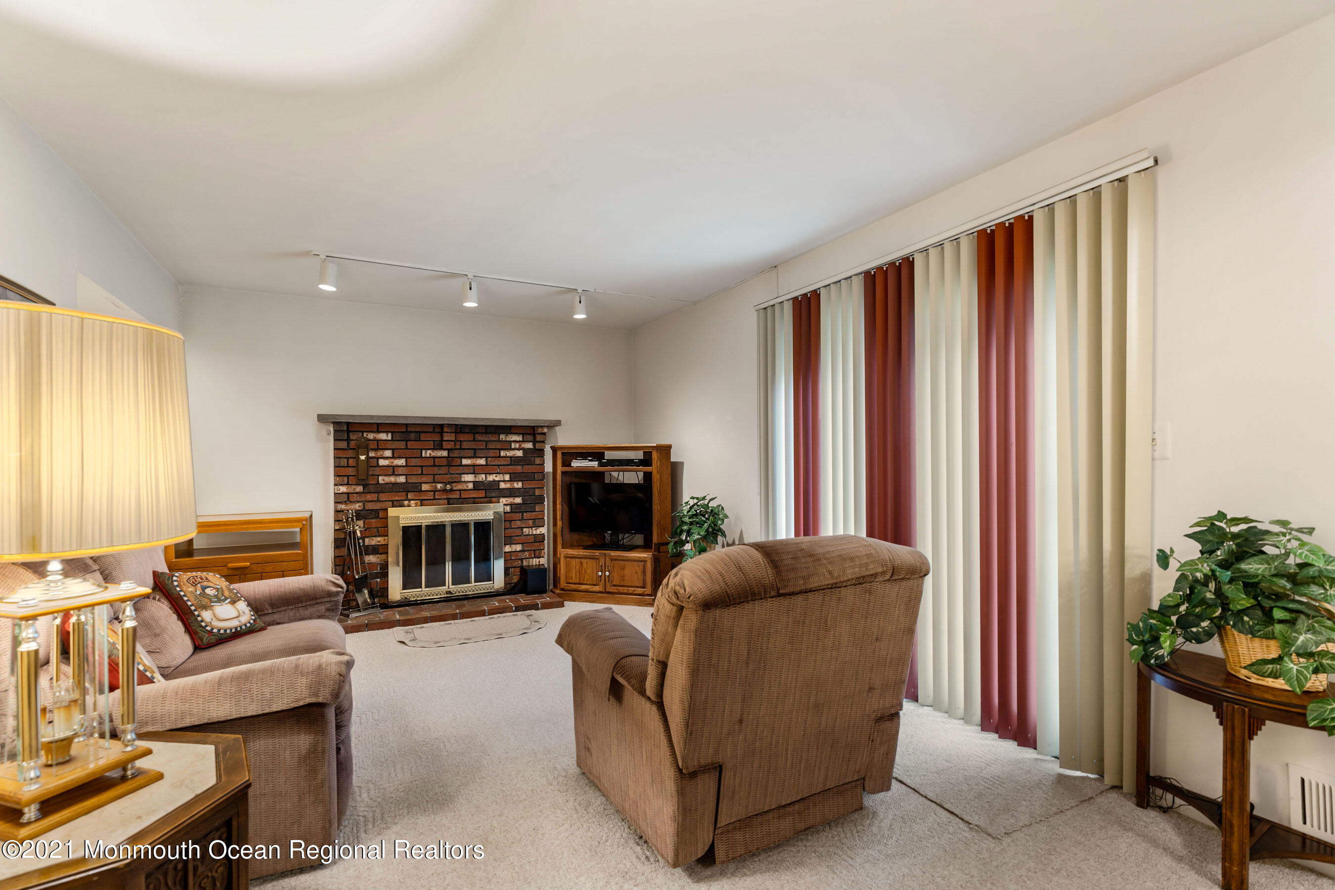 11 Flintlock Drive Howell, NJ 07731 - Photo 9 of 29 a living room with furniture a fireplace and a potted plant