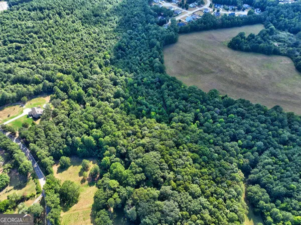 an aerial view of a house with a yard and swimming pool