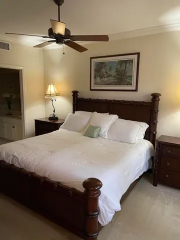 a bedroom with a bed and a lamp