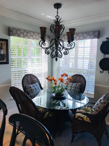 a view of a dining room with furniture and chandelier