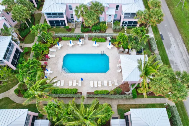 an aerial view of a house with a garden and lake view