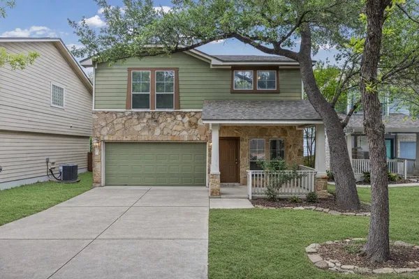 a view of an empty room with window and ceiling fan