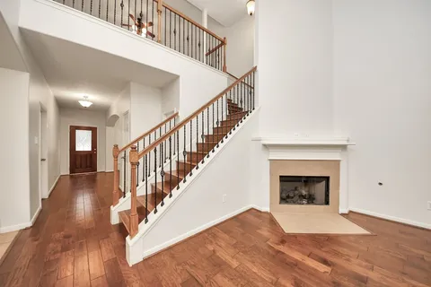a view of entryway and hall with wooden floor