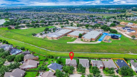 an aerial view of a house with swimming pool a yard and outdoor seating