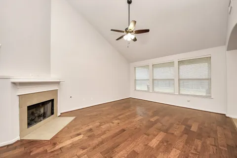 a view of empty room with windows and fireplace