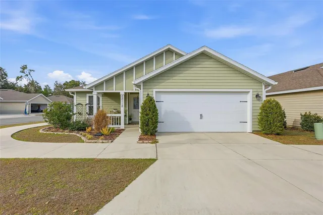 a view of a house with a yard and garage