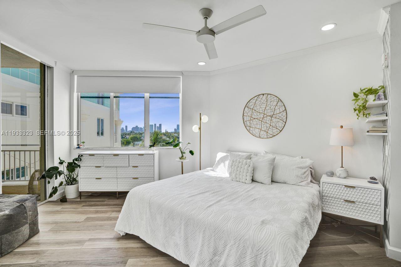 1 Century Lane, Unit 510 Miami Beach, FL 33139 - Photo 11 of 32 a bedroom with a large bed and a chandelier