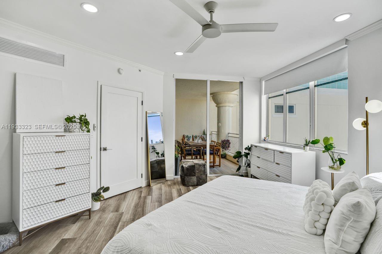 1 Century Lane, Unit 510 Miami Beach, FL 33139 - Photo 12 of 32 a bedroom with a bed and a dresser