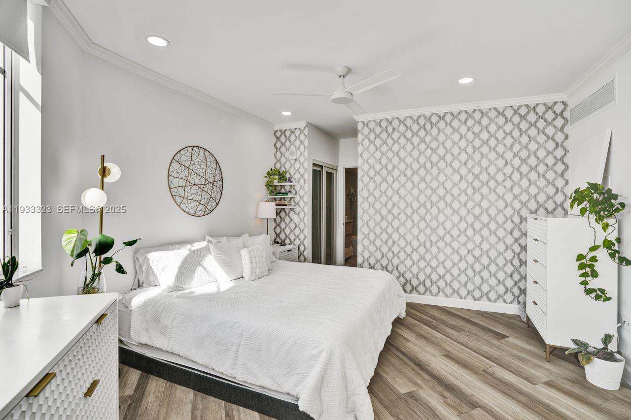 1 Century Lane, Unit 510 Miami Beach, FL 33139 - Photo 13 of 32 a bedroom with a bed and painting on the wall