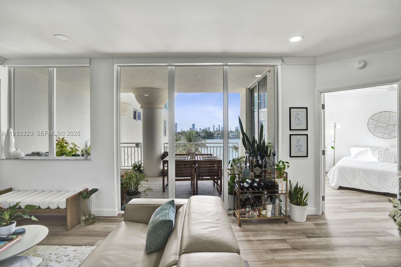 1 Century Lane, Unit 510 Miami Beach, FL 33139 - Photo 2 of 32 a living room with furniture large window and potted plants