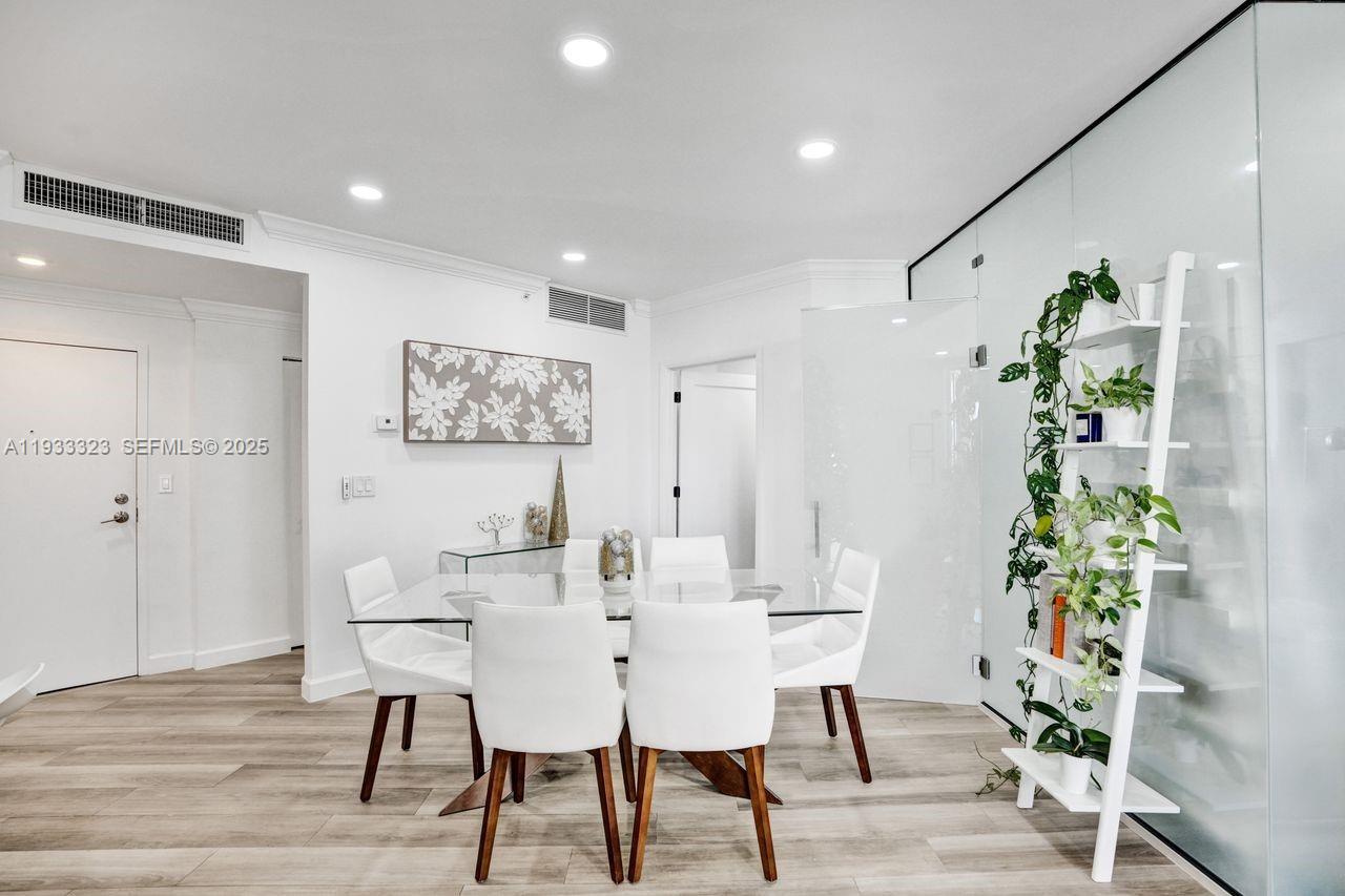 1 Century Lane, Unit 510 Miami Beach, FL 33139 - Photo 22 of 32 a view of a dining room with furniture and wooden floor