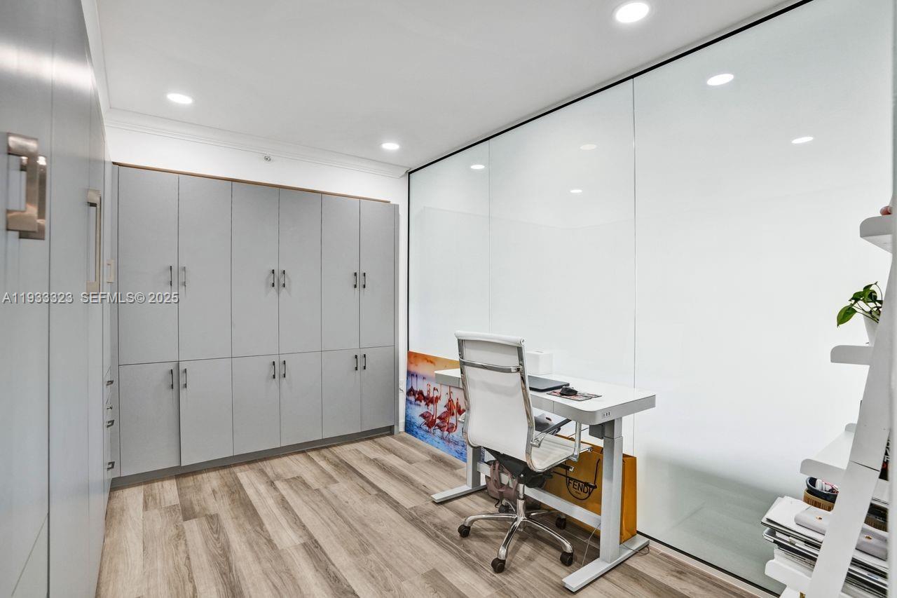 1 Century Lane, Unit 510 Miami Beach, FL 33139 - Photo 28 of 32 a view of a workspace with furniture and gym equipment