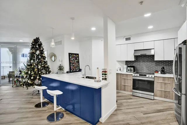 a kitchen with granite countertop cabinets and stainless steel appliances