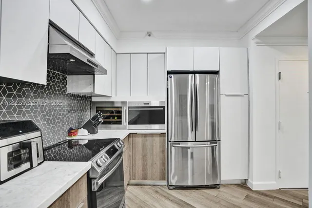a large white bed in a white room