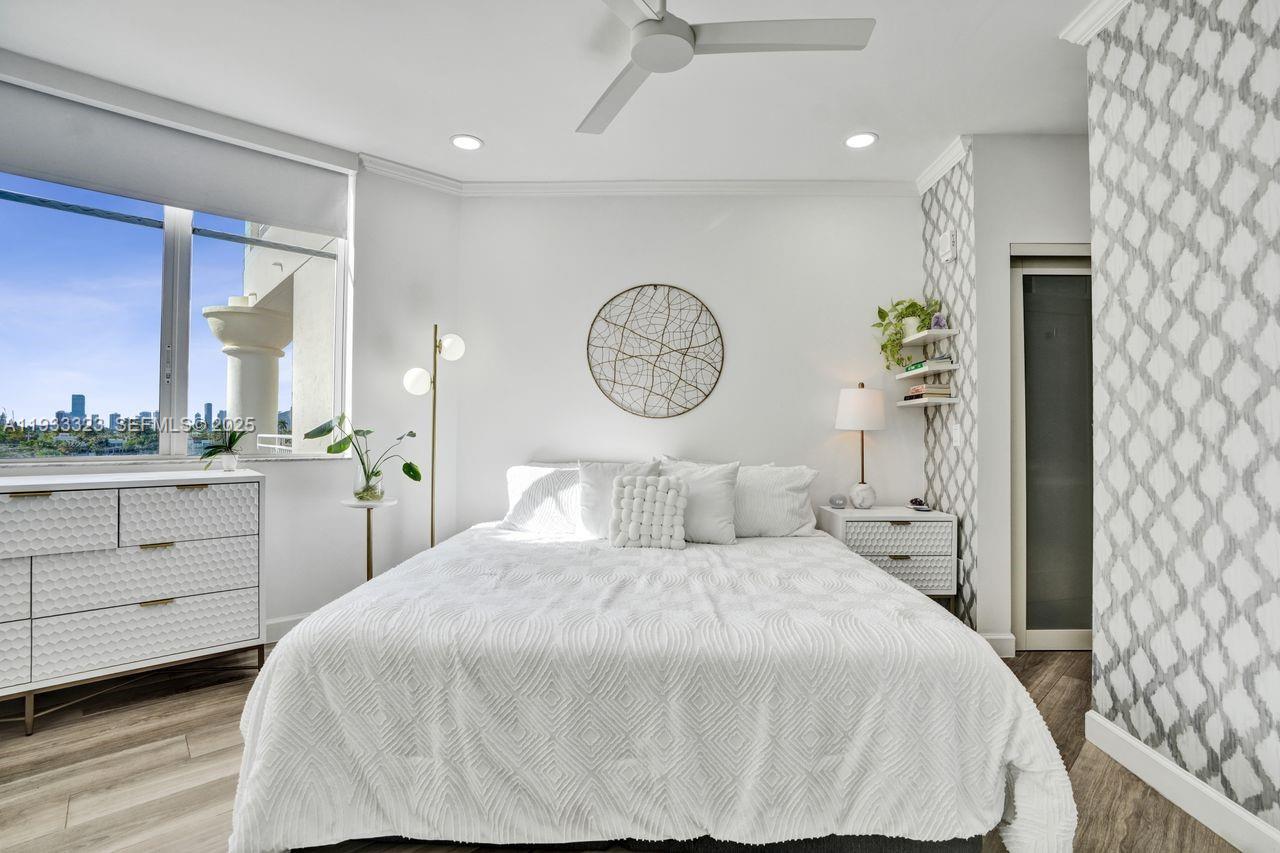 1 Century Lane, Unit 510 Miami Beach, FL 33139 - Photo 10 of 32 a large white bed in a white room