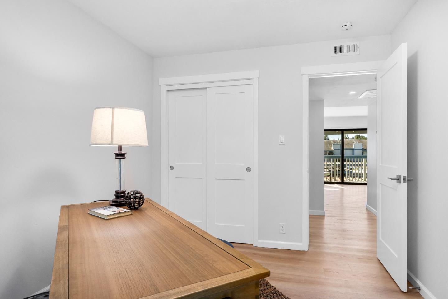 1925 46th Avenue, Unit 148 Capitola, CA 95010 - Photo 18 of 42 a room with a door and wooden floor