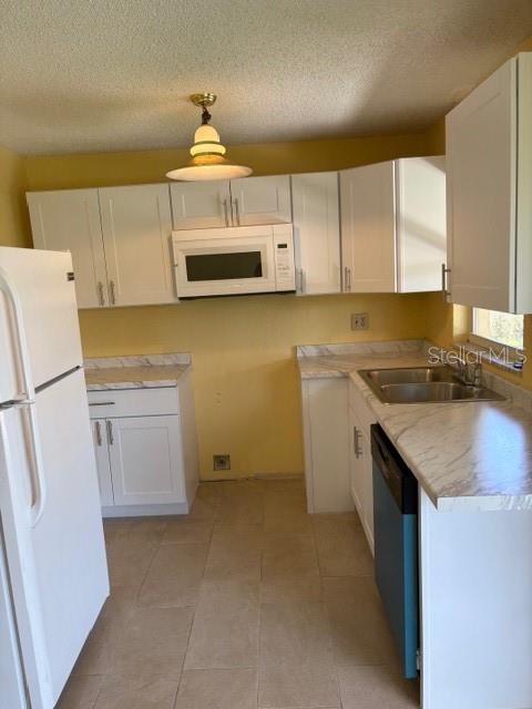 7544 Humboldt Avenue New Port Richey, FL 34655 - Photo 3 of 8 a kitchen with a sink a stove and cabinets