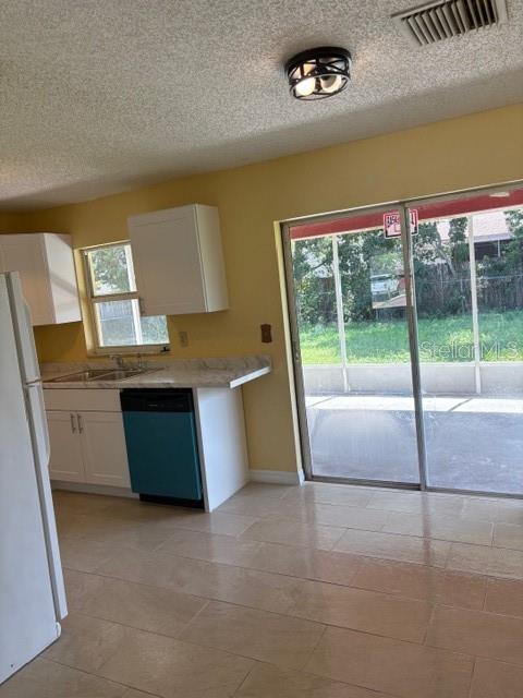7544 Humboldt Avenue New Port Richey, FL 34655 - Photo 4 of 8 a kitchen with stainless steel appliances granite countertop a stove a sink and a microwave