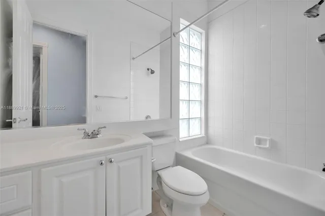 a bathroom with a sink toilet vanity and bathtub