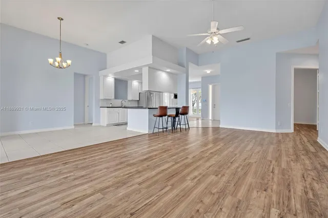 a view of a kitchen with a table and chairs