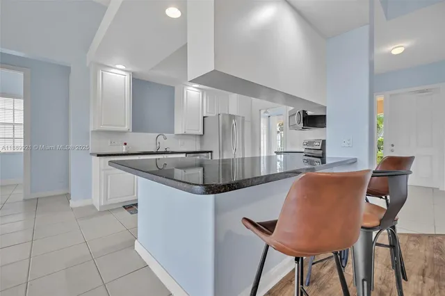 a kitchen with stainless steel appliances a sink and a refrigerator