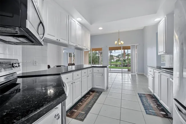 a large kitchen with a large window and stainless steel appliances