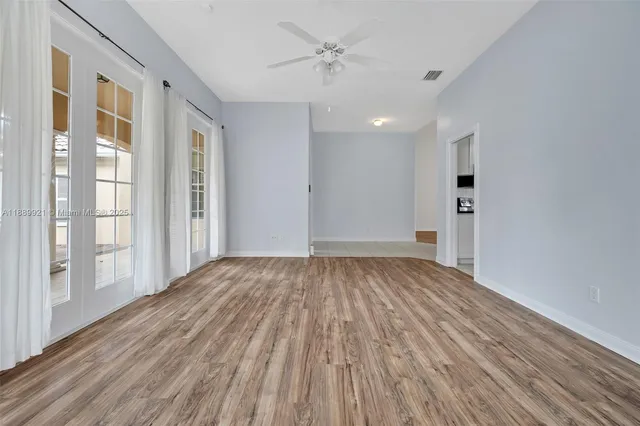 wooden floor in an empty room with a window